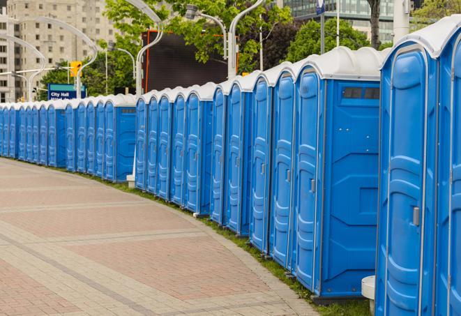 a clean row of portable restrooms for outdoor weddings or festivals in Commiskey, IN